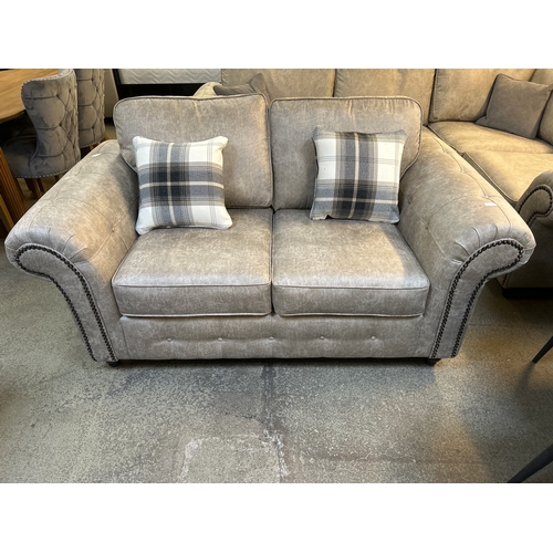 1575 - A Champagne vegan leather upholstered two seater sofa