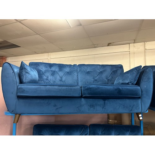 1557 - A Hoxton blue velvet upholstered three seater sofa