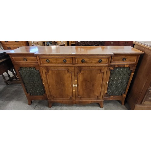 183 - A Regency style inlaid yew wood breakfront sideboard