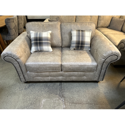 1302 - A Champagne vegan leather upholstered two seater sofa