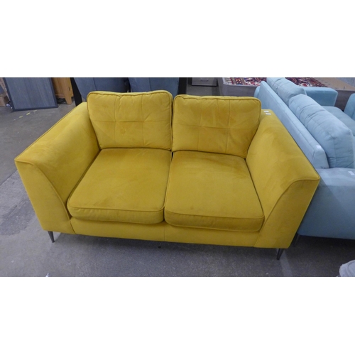 1354 - A turmeric velvet two seater sofa