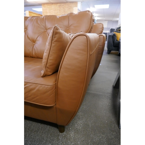1387 - A tan leather Hoxton love seat, RRP £1539