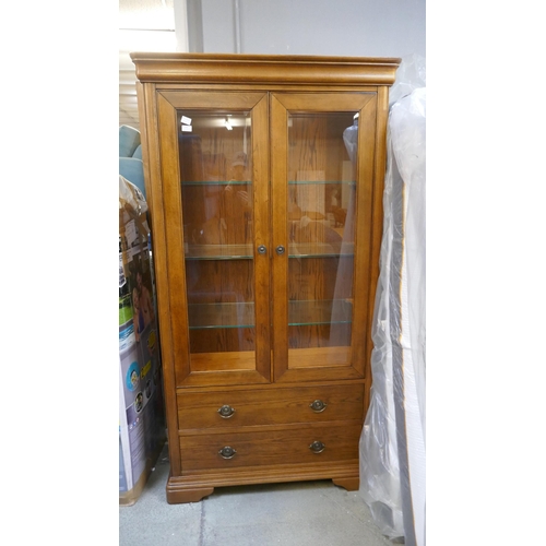 1561 - An oak two door, two drawer glazed display cabinet