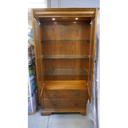 1561 - An oak two door, two drawer glazed display cabinet