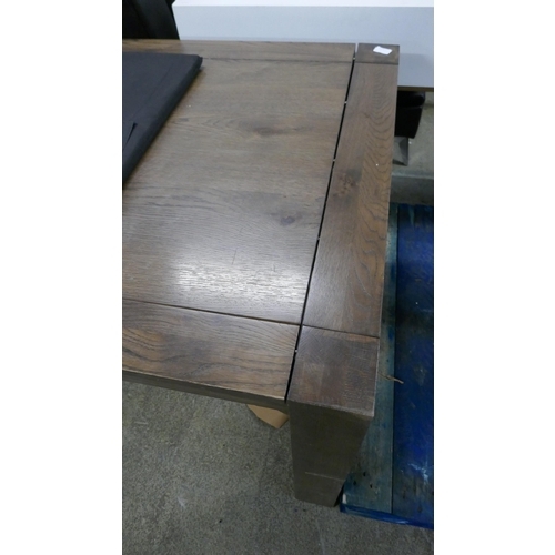 1579 - An oak effect dining table - damaged