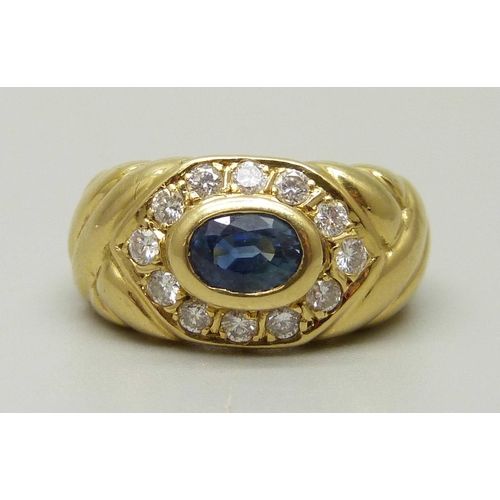 1006 - An 18ct gold, blue stone ring with twelve stone diamond halo, marked 18ct and 750, 8g, M