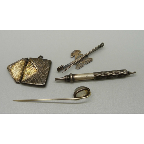 1041 - A silver stamp holder, Chester, a sterling silver and moonstone tie pin, a silver sweetheart brooch ... 