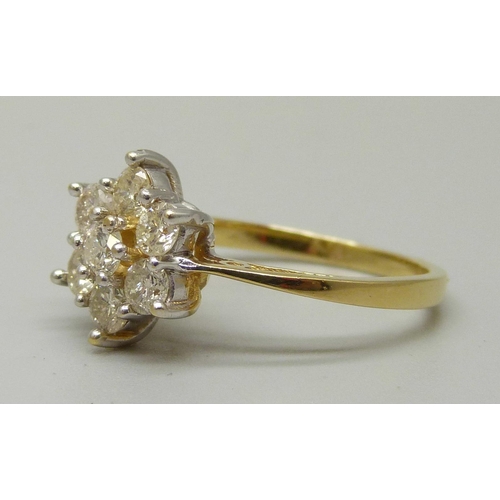 1054 - An 18ct gold, seven stone diamond cluster ring, total brilliant cut diamond weight 1ct, 3.7g, M