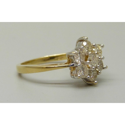 1054 - An 18ct gold, seven stone diamond cluster ring, total brilliant cut diamond weight 1ct, 3.7g, M