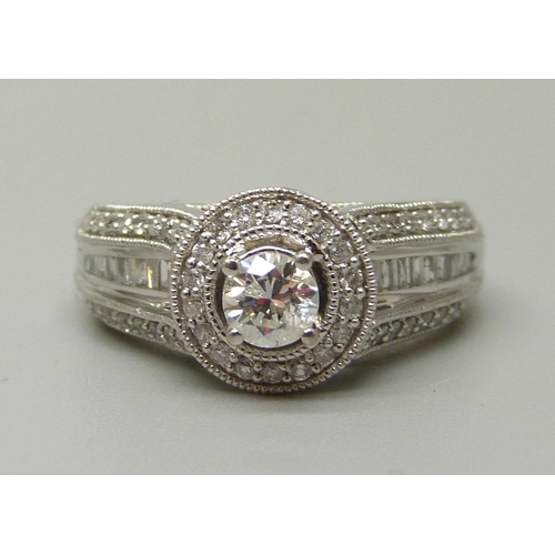 1057 - A 10ct white gold and 83 stone diamond ring, centre diamond 0.35ct plus 82 0.01 diamonds, total diam... 