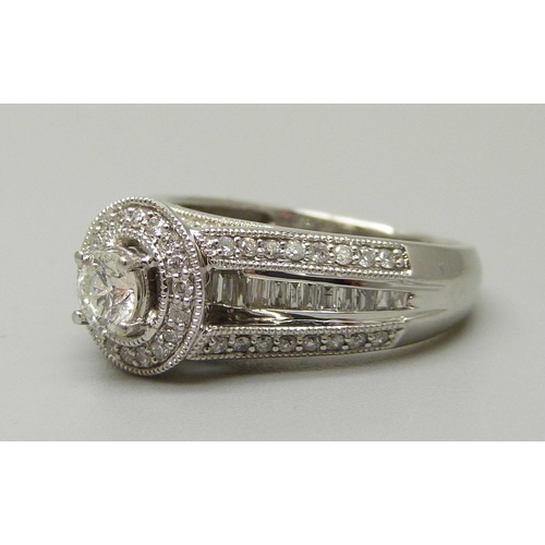 1057 - A 10ct white gold and 83 stone diamond ring, centre diamond 0.35ct plus 82 0.01 diamonds, total diam... 