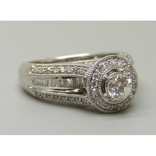 1057 - A 10ct white gold and 83 stone diamond ring, centre diamond 0.35ct plus 82 0.01 diamonds, total diam... 