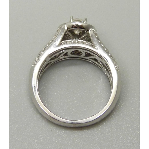 1057 - A 10ct white gold and 83 stone diamond ring, centre diamond 0.35ct plus 82 0.01 diamonds, total diam... 