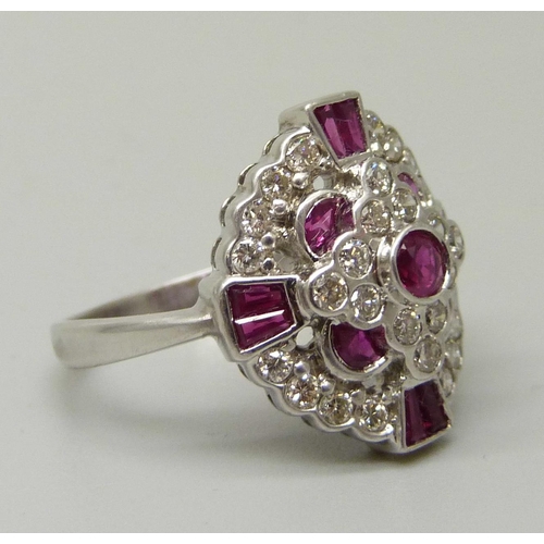 1059 - An 18ct gold, 12 ruby and 28 diamond cluster ring, 5.6g, M