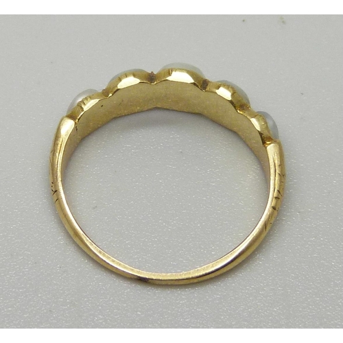 1072 - A yellow metal ring set with five half seed pearls, sizes approximately from 3.6mm to 5.4mm, 2.1g, J