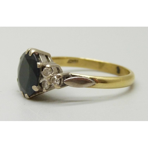 1075 - An 18ct gold ring set with a central sapphire measuring approximately 1.73ct, six diamonds set on th... 