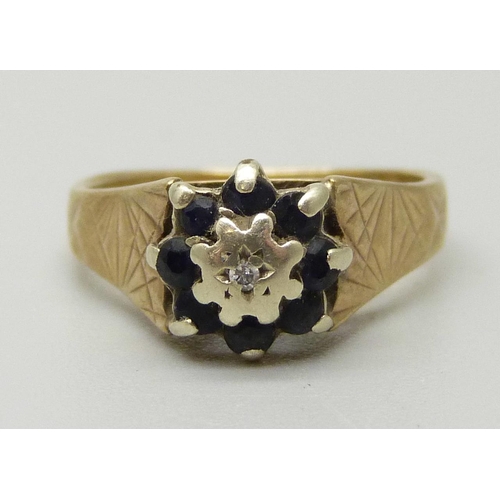 1078 - A 9ct gold cluster ring set with a central illusion set diamond weighing approximately 0.02ct, surro... 