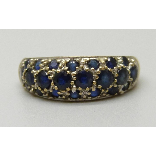 1080 - A 9ct gold pave set ring with eight sapphires measuring approximately 3.2mm and fourteen measuring a... 