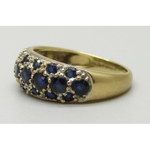 1080 - A 9ct gold pave set ring with eight sapphires measuring approximately 3.2mm and fourteen measuring a... 