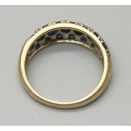 1080 - A 9ct gold pave set ring with eight sapphires measuring approximately 3.2mm and fourteen measuring a... 