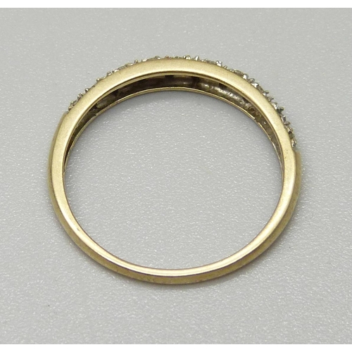 1081 - A 9ct gold ring set with small diamonds, 1.4g, O