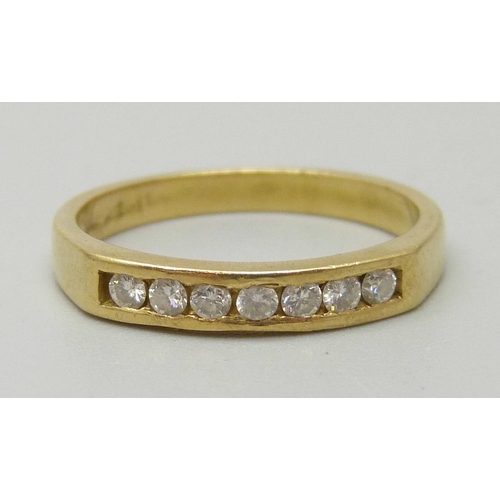 1082 - A yellow metal ring set with seven diamonds, approx 1.9mm, weighing approximately 0.21ct, 3.1g, N/O