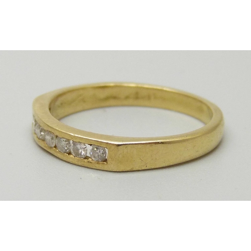 1082 - A yellow metal ring set with seven diamonds, approx 1.9mm, weighing approximately 0.21ct, 3.1g, N/O