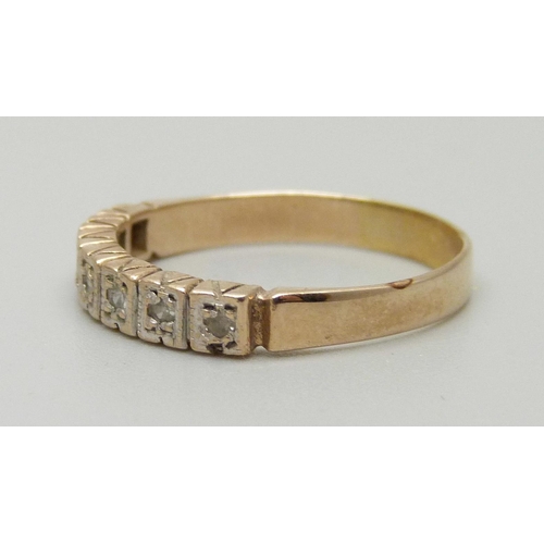 1084 - A 9ct gold ring set with seven diamonds, approximately 0.14ct, Birmingham, 1979, marked LDP, 2.6g, S