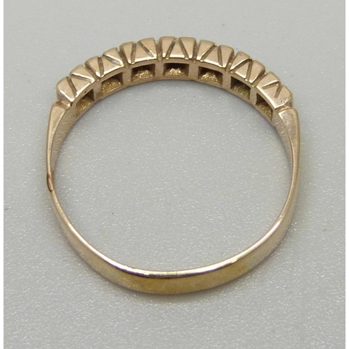 1084 - A 9ct gold ring set with seven diamonds, approximately 0.14ct, Birmingham, 1979, marked LDP, 2.6g, S