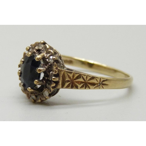 1085 - A 9ct gold cluster ring with central sapphire measuring approximately 0.78ct surrounded by eight dia... 