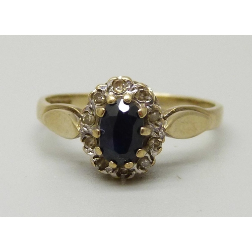 1089 - A 9ct gold cluster ring with an oval central sapphire measuring approximately 5.5 x 3.5 x 2.5mm weig... 