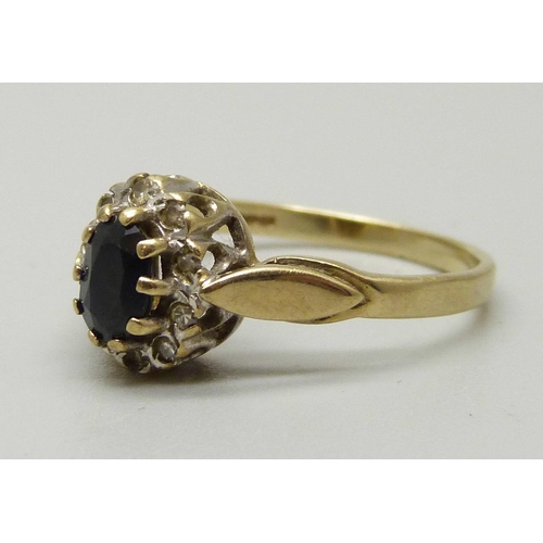 1089 - A 9ct gold cluster ring with an oval central sapphire measuring approximately 5.5 x 3.5 x 2.5mm weig... 