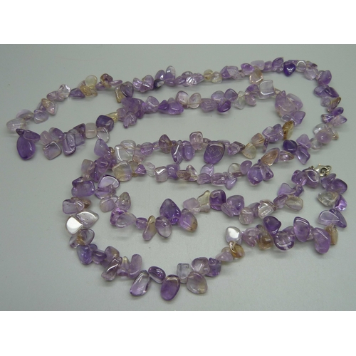 1111 - A long amethyst necklace with silver clasp