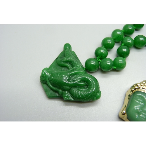 1125 - A jade style bead necklace with dragon pendant and a Buddha pendant