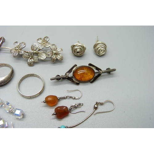 1131 - A collection of silver jewellery including two brooches, pendant, rings, etc.