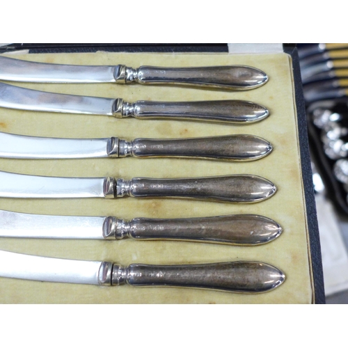 1158 - Six silver handled butter knives, cased, a collection of plated flatware, cased and two Royal Doulto... 