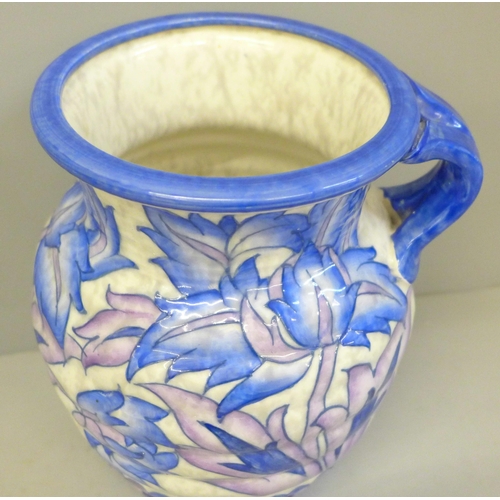603 - A Crown Ducal Charlotte Rhead pitcher/vase blue peony pattern, base with star crack, 20cm