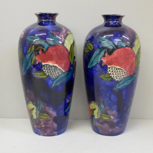 607 - A pair of Rubens Ware vases decorated with open pomegranates, 24cm