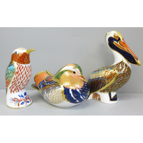 668 - Three Royal Crown Derby paperweights, Brown Pelican, Mandarin Duck and Hummingbird, boxed