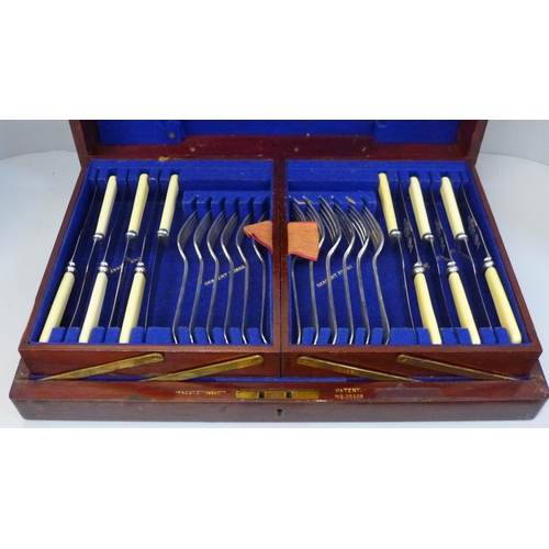 704 - A set of silver plated handled knives and a wooden canteen of cutlery