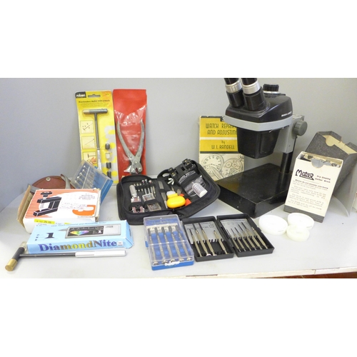 782 - A collection of watch repair equipment including tools, a microscope, diamond tester, etc.