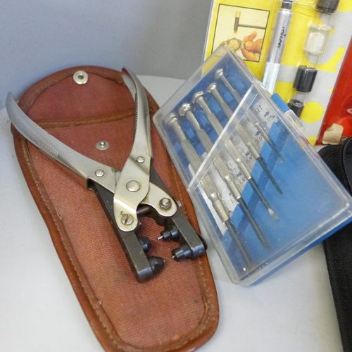 782 - A collection of watch repair equipment including tools, a microscope, diamond tester, etc.