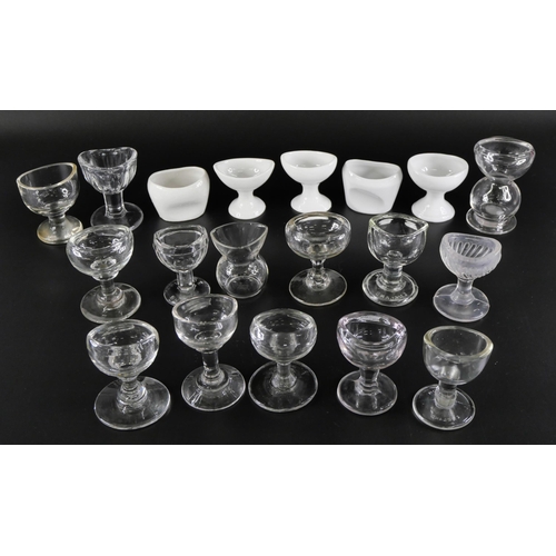 826 - A collection of clear glass eye baths and ceramic eye baths (19)