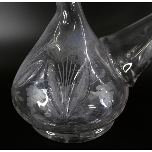 827 - An oversized spirit decanter engraved with flowers and foliage, and a sangria carafe