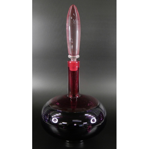 830 - Bob Crooks, a spiral glass decanter in amethyst and ruby, engraved signature to the base, 33cm