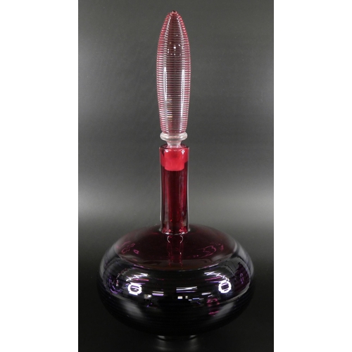 830 - Bob Crooks, a spiral glass decanter in amethyst and ruby, engraved signature to the base, 33cm