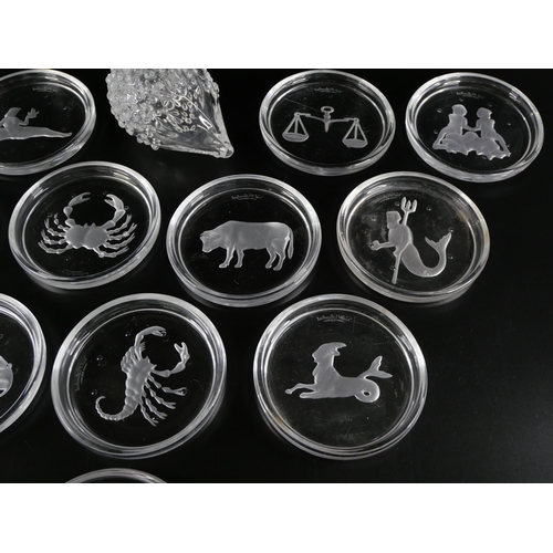 833 - A set of twelve astrological star sign wine coasters by Val St Lambert, and a glass hedgehog, signed