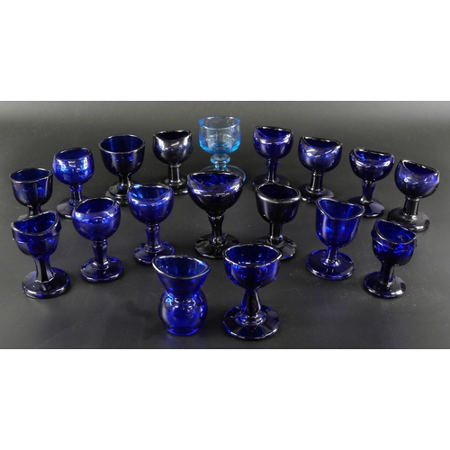 838 - Eighteen blue glass eye baths, some hand blown