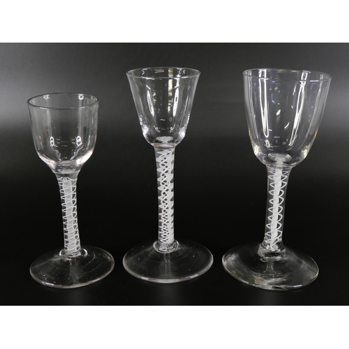 853 - Three 18th Century wine glasses with double series opaque twists