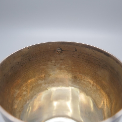 896 - A Georgian white metal beaker, with two continental control marks, tests as silver, 77.8g, 74mm